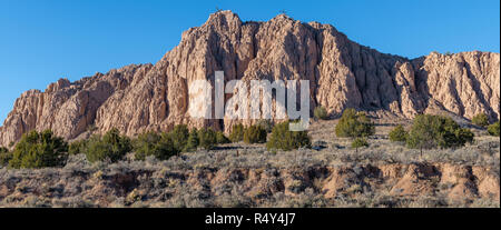 Panoramic view of a sandstone rock formation with two rustic wood crosses on the ridge top - Barrancos Blancos in the Rio Grande Gorge in New Mexico Stock Photo