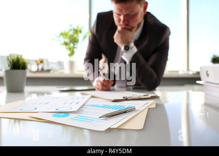Silver pen lie at important paper on table in office Stock Photo