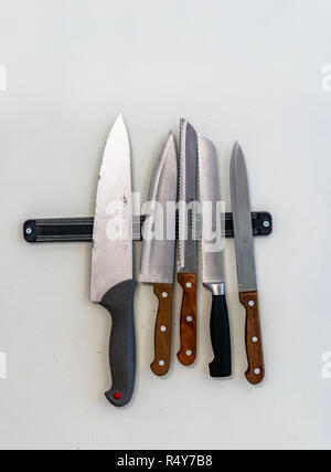 Some Kitchen Knives Hanging on the Kitchen Wall - Tool Set Stock Photo