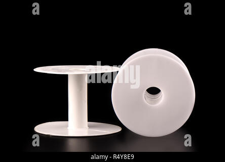 Two plastic empty spools for tape on a black background Stock Photo