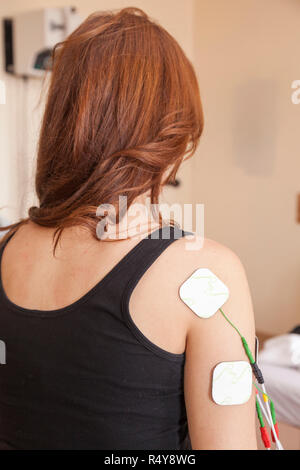Patient doing some special exercises under supervision of physical therapist Stock Photo