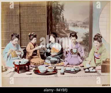 A group of Japanese women eating a meal in a traditional house. Wearing formal traditional costumes of kimono and obi with decorated dressed hair. Sitting on the floor. . Scenes from life in Japan. Circa 1880s Hand-coloured albumen print. Source: Photo 752/24 47. Stock Photo