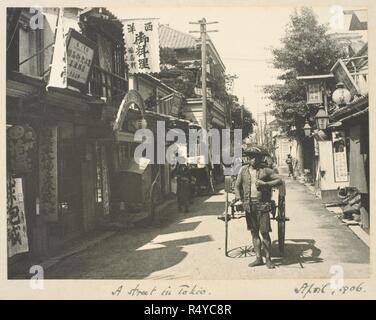 A photograph of a nineteenth-century Tokyo street. A young man pulling a rickshaw. Zetland Collection: Album of views of ... Japan and ... Apr-06. Source: Photo 364/7(8). Language: English. Author: Zetland, 2nd Marquess of. Abbott, William. Stock Photo