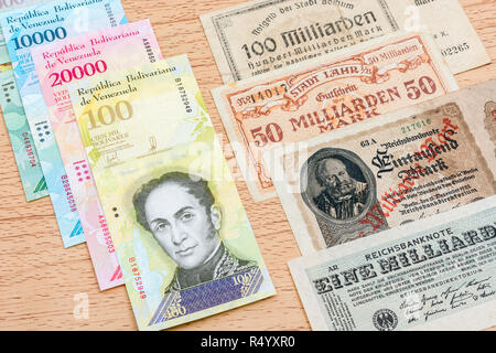 Hyperinflation - 2 classic cases: Germany 1920s (1 Billion to 100 Billion Mark notes), with Venezuelan 100,000 Bolivar banknote. Stock Photo