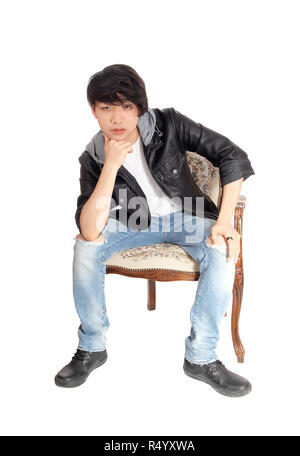 Asian teenager sitting in chair. Stock Photo