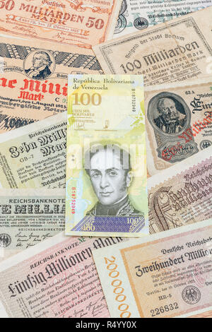 Hyperinflation - 2 classic cases: Germany 1920s (various 1 Million to 100 Billion Mark notes), with Venezuelan 100,000 Bolivar banknote. Stock Photo