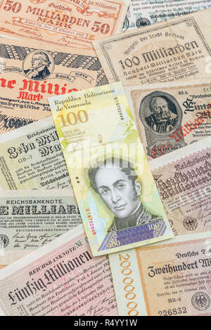 Hyperinflation - 2 classic cases: Germany 1920s (various 1 Million to 100 Billion Mark notes), with Venezuelan 100,000 Bolivar banknote. Stock Photo