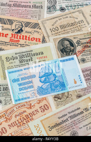 Hyperinflation - 2 classic cases: Germany 1920s (1M to 100Bn marks) Zimbabwe 100 Trillion Dollar (largest denomination banknote ever printed, in 2008) Stock Photo