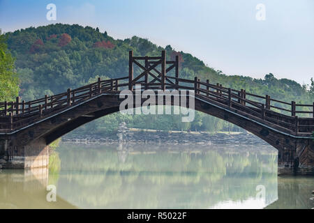 Chinese bridge on a calm canal. At Chibi city. the bridge made from the wooden. Ancient Bridge in three kingdom battle field in Hubei China. Stock Photo