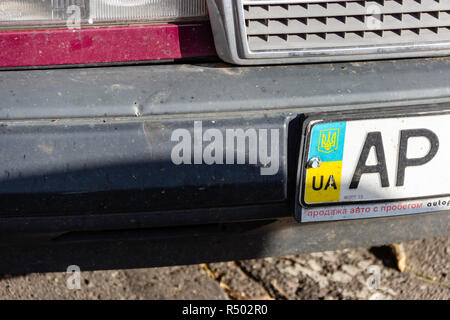 DNIPRO, UKRAINE - NOVEMBER 1, 2018: Close up of the Ukrainian car license plate on the bumper. National emblem on background of flag colors. Advertise Stock Photo