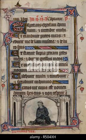 Bas-de-page scene of a monk with bound hands and feet seated within a towered structure, with a caption reading, â€˜â€¦du moine liee'. Book of Hours, Use of Sarum ('The Taymouth Hours'). England, S. E.? (London?); 2nd quarter of the 14th century. Source: Yates Thompson 13, f.173. Language: Latin and French. Stock Photo