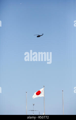 Japanese flag in wind with military helicopter Stock Photo