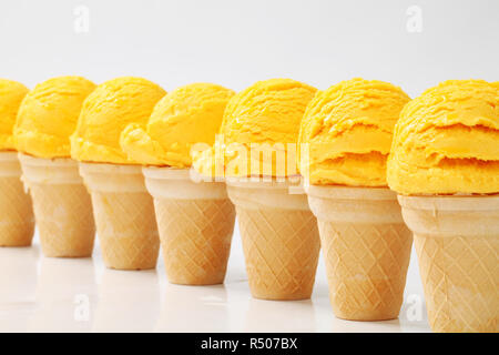 Yellow ice cream cones in a row Stock Photo