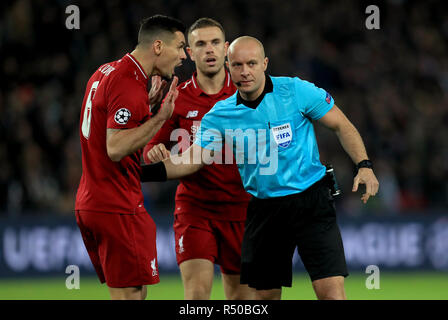 Liverpool's Dejan Lovren (left) and Jordan Henderson with match referee Szymon Marciniak during the UEFA Champions League, Group C match at the Parc des Princes, Paris. Stock Photo