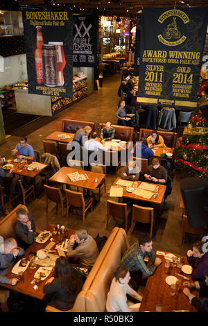 Lunchtime customers at tables in restaurant bar and brewery of Amsterdam Brewhouse restaurant at Harbourfront Toronto Stock Photo