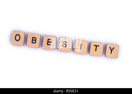 The word OBESITY, spelt with wooden letter tiles. Stock Photo