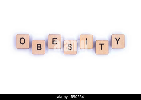 The word OBESITY, spelt with wooden letter tiles. Stock Photo