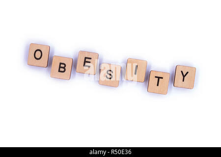 The word OBESITY, spelt with wooden letter tiles. Stock Photo