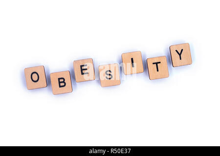 The word OBESITY, spelt with wooden letter tiles. Stock Photo