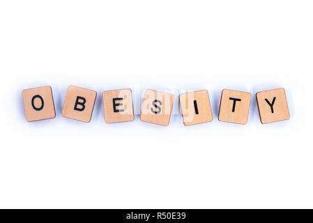 The word OBESITY, spelt with wooden letter tiles. Stock Photo