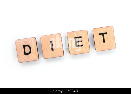 The word DIET - spelt with wooden letter tiles over a white background. Stock Photo