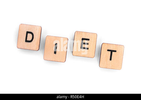 The word DIET - spelt with wooden letter tiles over a white background. Stock Photo