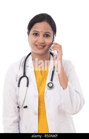 Young female doctor talking on mobile phone Stock Photo