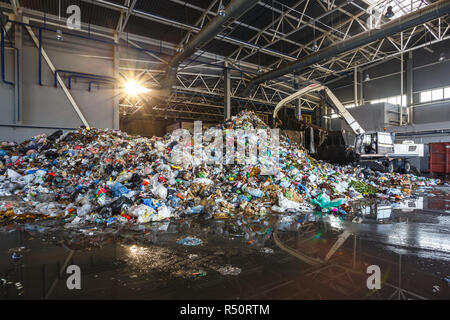 Separate garbage collection. Recycling and storage of waste for further disposal. Workers sorting material to be processed in a modern waste recycling Stock Photo