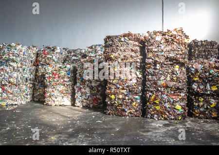 Plastic bales of rubbish at the waste treatment processing plant. Recycling separatee and storage of garbage for further disposal, trash sorting. Busi Stock Photo