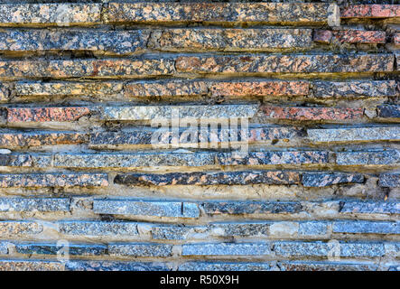 Wall from granite tiles. Close up Stock Photo