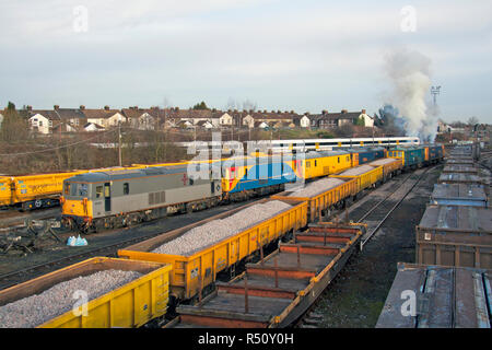 A pair of class 73 electro diesel locomotives numbers 73208 and 73206 make a smokey departure from Tonbridge yard with a loaded ballast working. Stock Photo