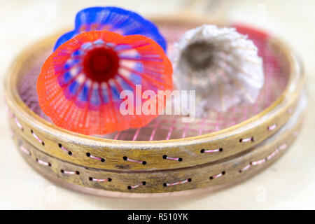 Old badminton accessories on a light table. Set for outdoor games and games. White background. Stock Photo