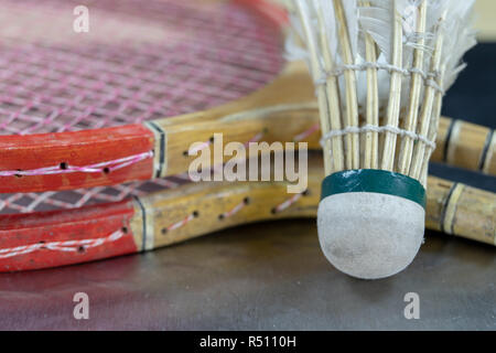 Old badminton accessories on a light table. Set for outdoor games and games. White background. Stock Photo