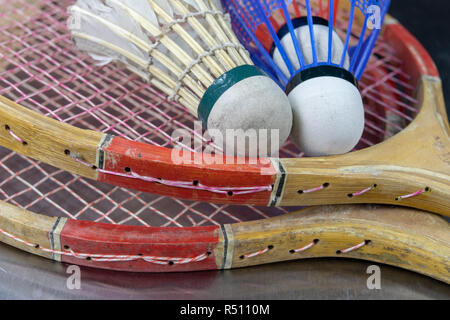 Old badminton accessories on a light table. Set for outdoor games and games. White background. Stock Photo