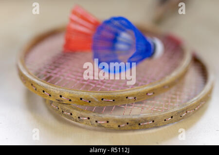 Old badminton accessories on a light table. Set for outdoor games and games. White background. Stock Photo