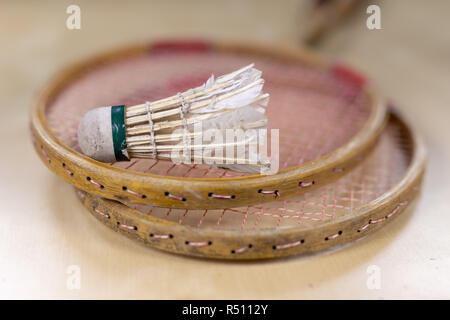 Old badminton accessories on a light table. Set for outdoor games and games. White background. Stock Photo
