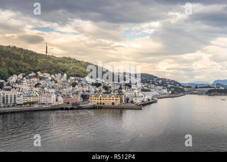 The fjord of Alesund, a tranquil port town with Nouveau style, and Mount Aksla in the background at the entrance to the Geirangerfjord, Norway. Stock Photo