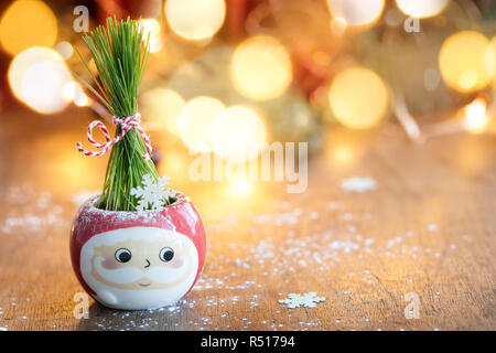 Fresh Green wheat in Santa cup with Christmas lights and decoration on background Stock Photo