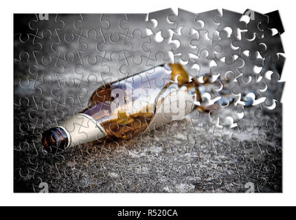 Puzzle of a broken bottle of beer resting on the ground - Alcoholism addiction concept image Stock Photo