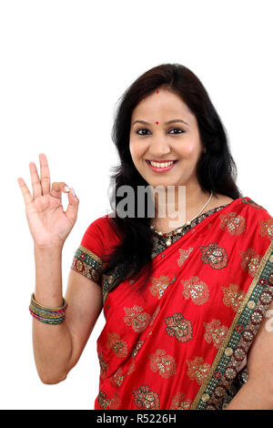 Traditional Indian Young woman making OK sign Stock Photo