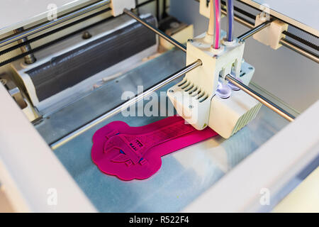 Close Up of 3D printer while printing screw wrench or screw spanner. 3D printing in progress. New generation of 3D Printing Machine. For use in small  Stock Photo