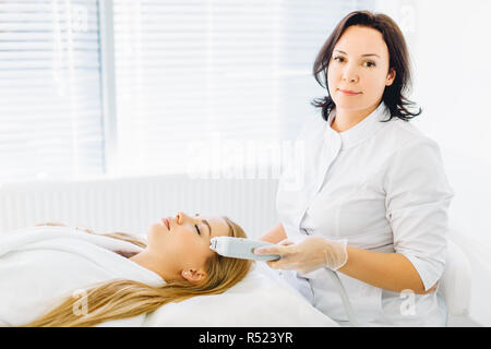 Face skin care. Woman getting facial laser treatment Stock Photo