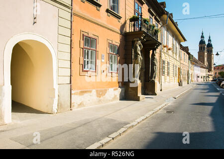 Sibiu, Romania - JUL 25, 2017: Places of interest on Mitropoliei street in Sibiu. Xenopol Passage entrance and Holy Trinity Cathedral in the distance. Stock Photo