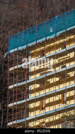 Scaffold Security Cladding building with scaffolding during installation of insulation panels to ...