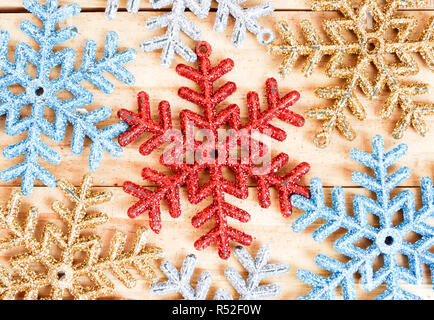 Full frame snowflakes background on the wooden board Stock Photo