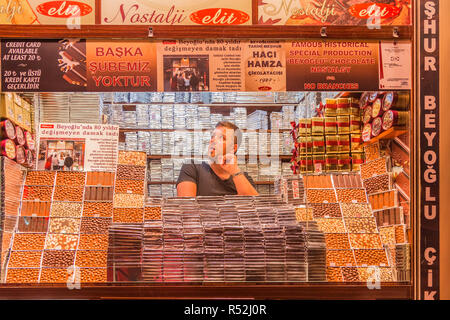 Istanbul, Turkey, June 17, 2014: Man in shop selling handmade chocolate in Istiklal. Stock Photo