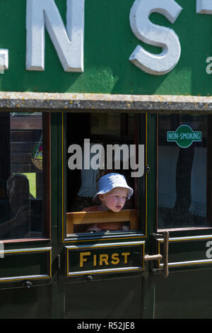 Child passenger / passengers aboard First / 1st class train carriage on the historic Isle of Wight steam Railway line, seen at Havenstreet Main Road, Haven Street station, Isle of Wight. England UK Stock Photo
