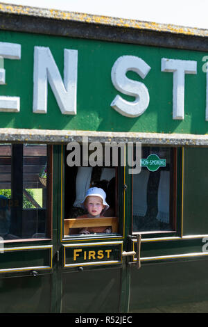 Child passenger / passengers aboard First / 1st class train carriage on the historic Isle of Wight steam Railway line, seen at Havenstreet Main Road, Haven Street station, Isle of Wight. England UK Stock Photo