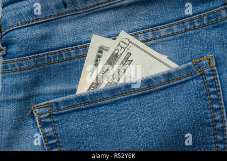 Jeans pocket with one hundred dollars banknotes. Stock Photo