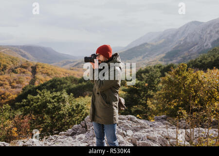 Male photographer walking in nature Stock Photo